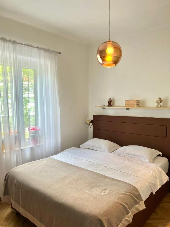 a bedroom with a large bed and a window at Apartment Kiki in Kotor