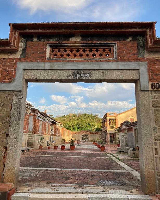 an entrance to an old building in a city at Shenten Homestay in Jincheng