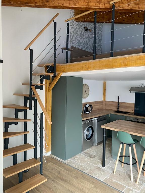 un loft conversiones de cocina y comedor con una escalera de caracol en Le Gîte de Maxou en Montauban