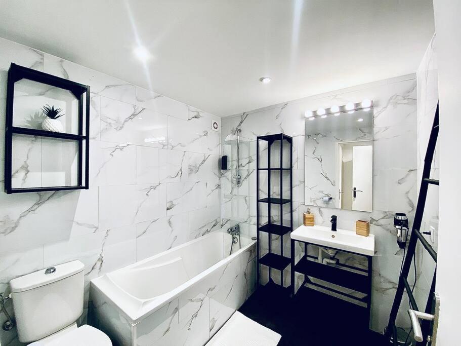 biała łazienka z wanną i umywalką w obiekcie Appartement Centre ville, Cannes le Suquet w Cannes