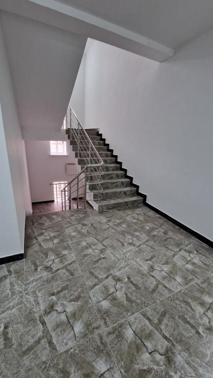 an empty room with stairs and a stone floor at Посуточная квартира! Аркада 37 in Taldykolʼ