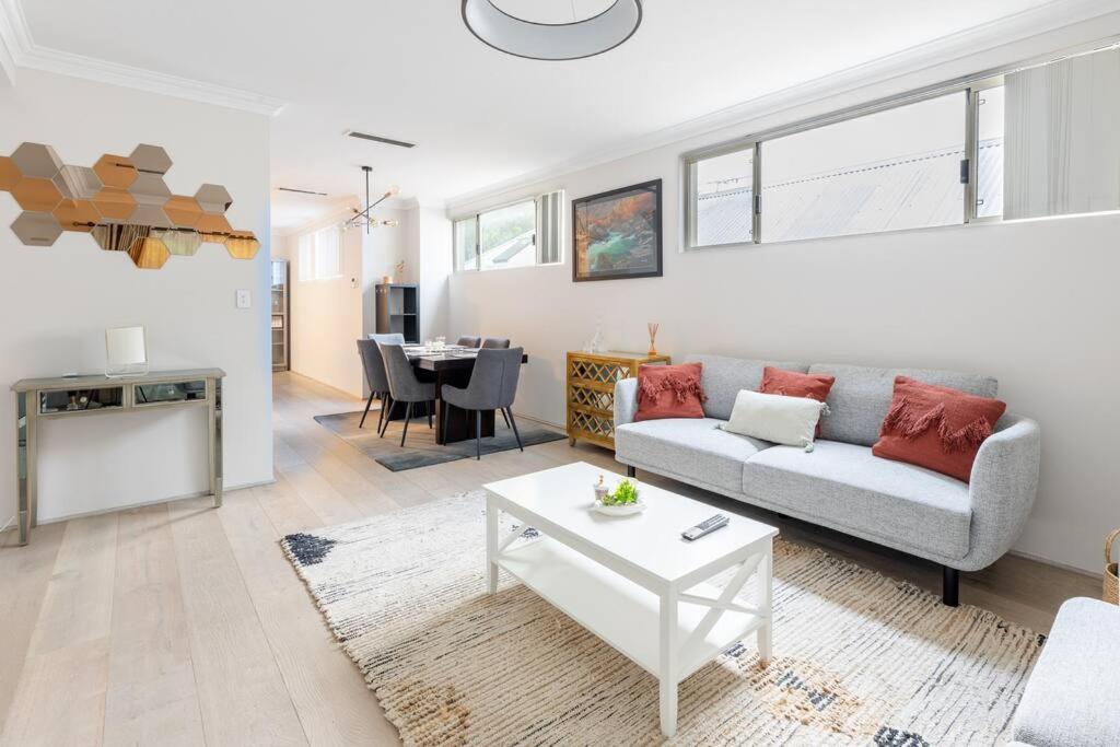 a living room with a couch and a table at Modern Town house - Close to CBD in Perth