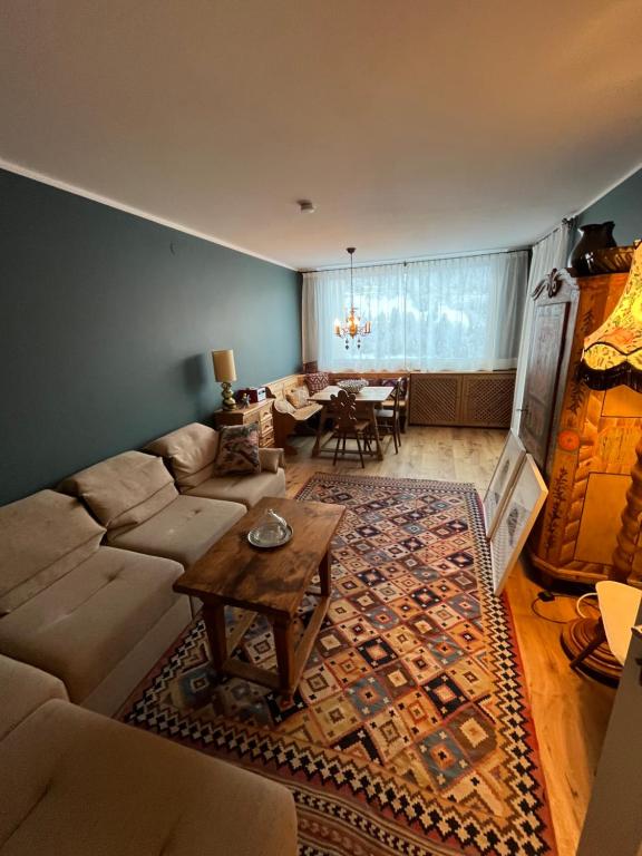 a living room with a couch and a table at Art & View - Apartment in Bad Gastein