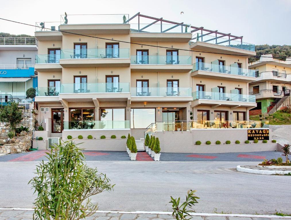 un grande edificio con un parcheggio di fronte di Kavala Resort & Spa a Néa Karváli