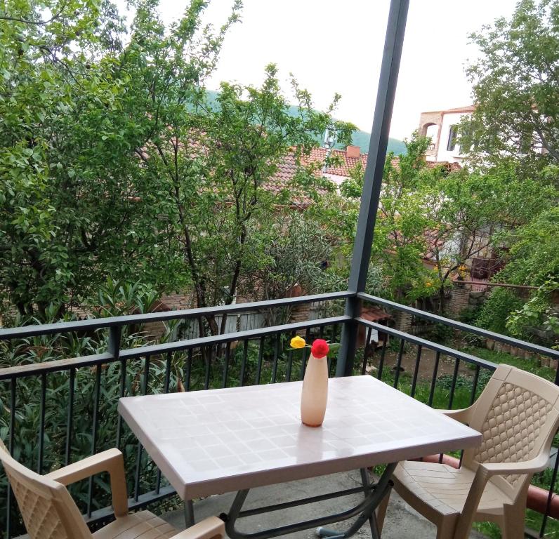 una mesa blanca con un jarrón en el balcón en Kizikis Kari, en Signagi