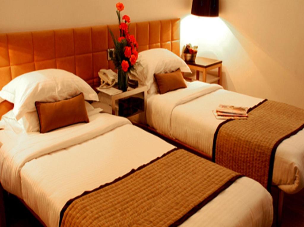 Postel nebo postele na pokoji v ubytování Hotel Palace Heights