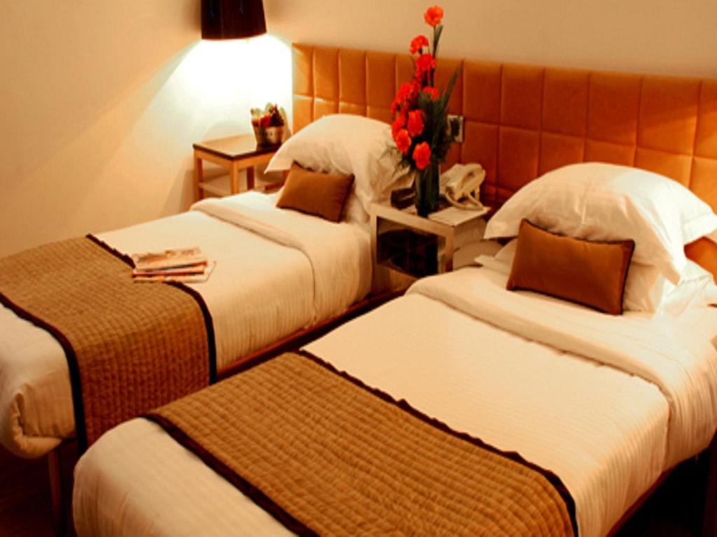 Postel nebo postele na pokoji v ubytování Hotel Palace Heights