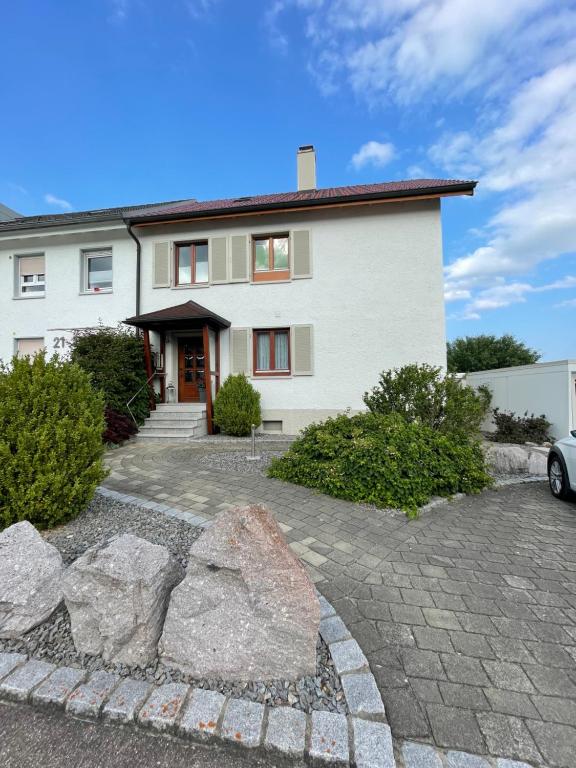 a white house with rocks in front of it at Petras Ferienwohnung in Villingen-Schwenningen