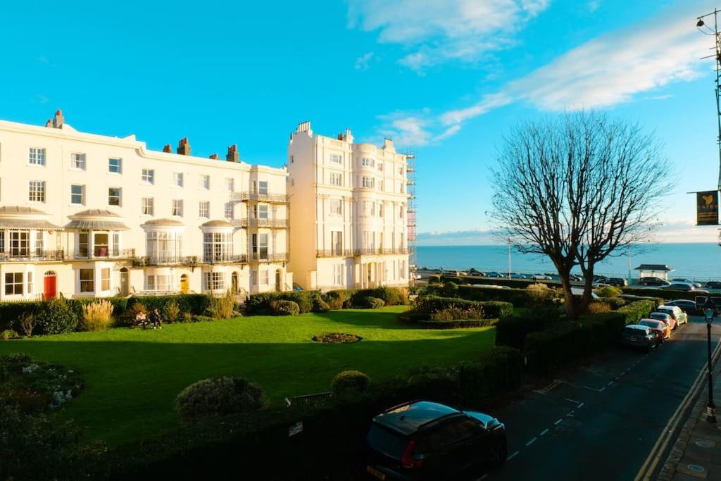 a large white building with cars parked in front of it at Stunning flat in Brighton & Hove - Central luxury. in Brighton & Hove