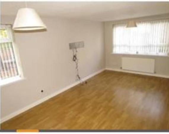 an empty living room with a hard wood floor at Beech Park in Deysbrook