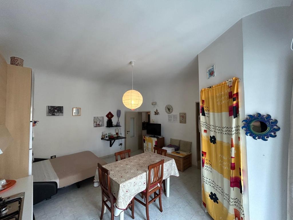 a living room with a table and a bedroom at Piero's Home in Castellana Grotte