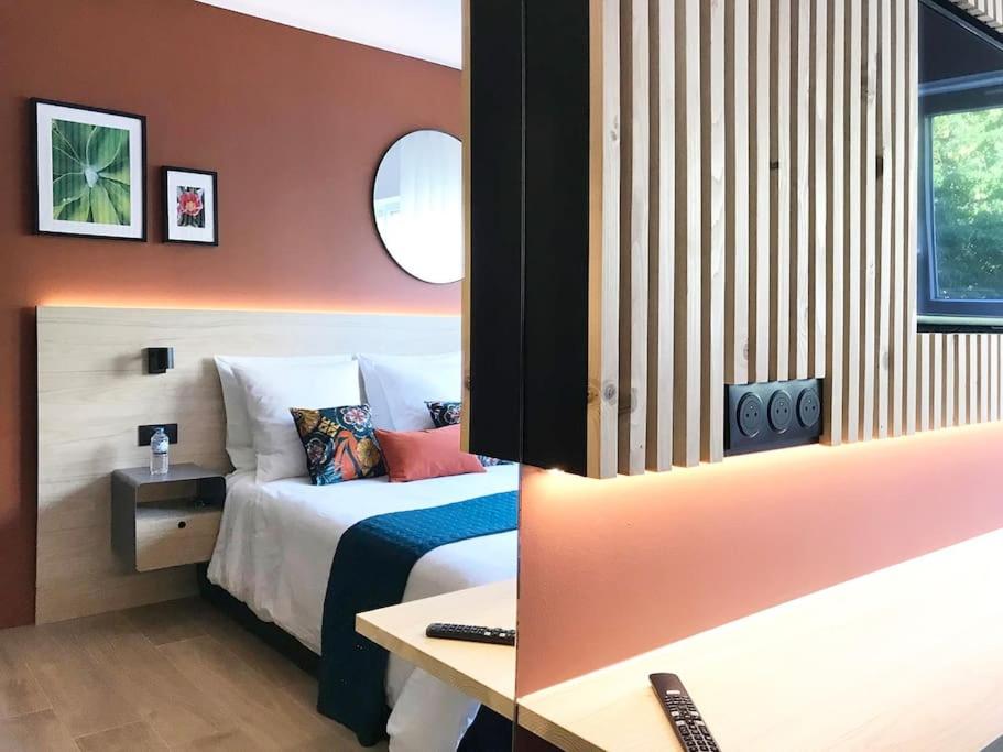 a hotel room with a bed and a desk at Studio Chic Croix-Barbieux in Croix