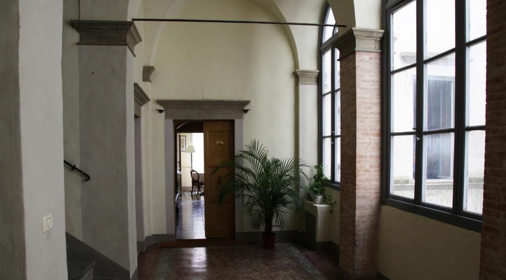 a hallway with a door and a potted plant at La Corte in Foligno