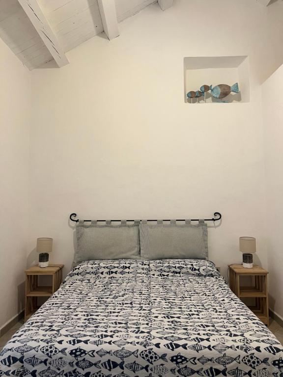 a bedroom with a bed and two night stands at Appartamento il Caracolo a Cala Francese in La Maddalena