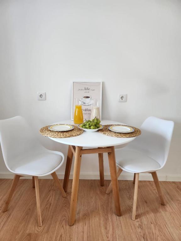 a table with two chairs and a plate of food on it at Janela D’Ouro in Peso da Régua