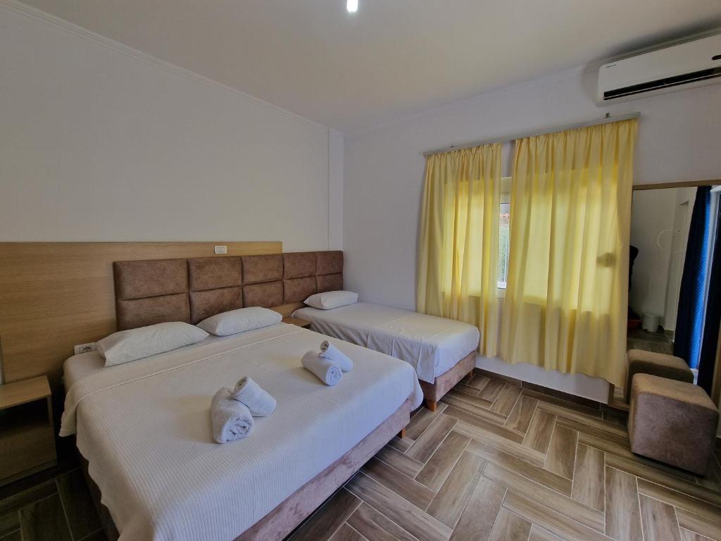 a hotel room with two beds and a window at Studio Eno Ksamil in Ksamil