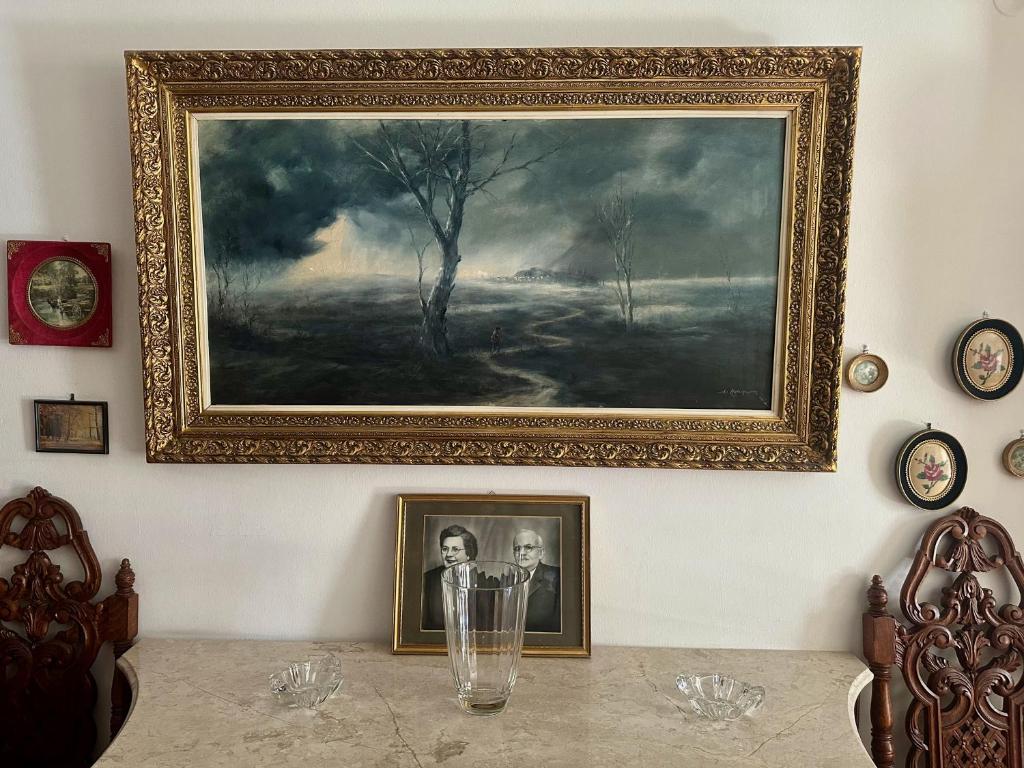 a painting on a wall with a picture on it at Vintage-style 2 bedroom apartment at Katechaki in Athens