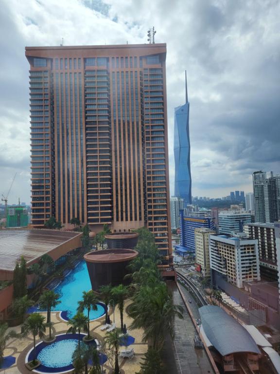 a view of a tall building with a pool in front of it at KL Time Square suit At Times square in Kuala Lumpur