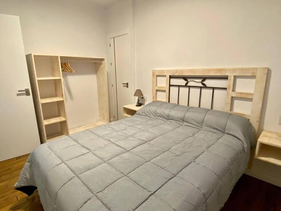 ein Schlafzimmer mit einem großen Bett und einem Bücherregal in der Unterkunft Casa Buitreras in El Colmenar