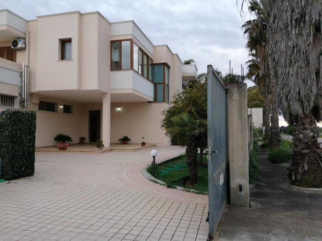 a large house with a gate in front of it at Casa Federica in Taviano