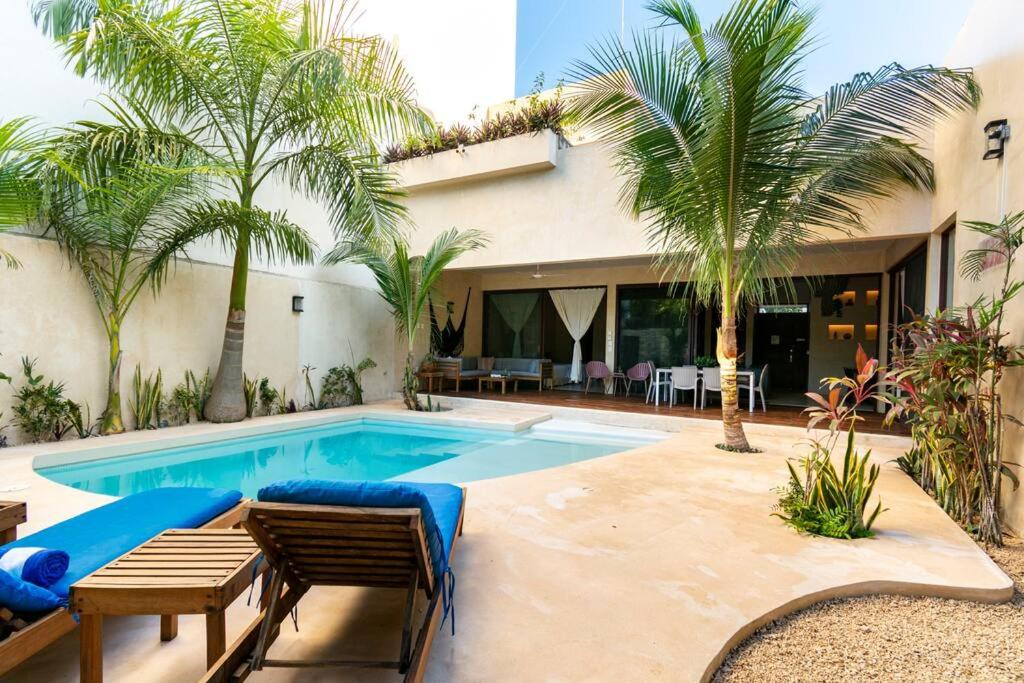 uma piscina com palmeiras e uma casa em Casa Esperanza Tulum Private Pool em Tulum