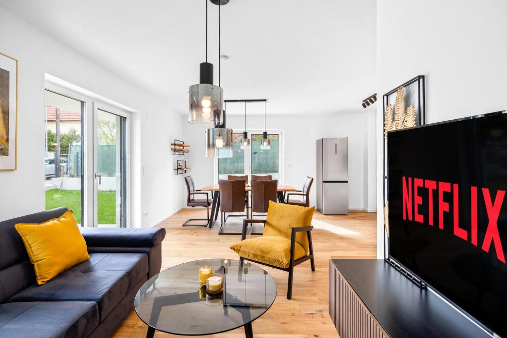 a living room with a couch and a tv at Apartments nähe Schloss Schönbrunn in Vienna