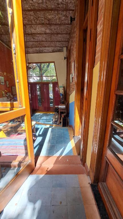 an empty hallway of a building with a door open at Boutique Hotel Casa Rugantino in Buenos Aires