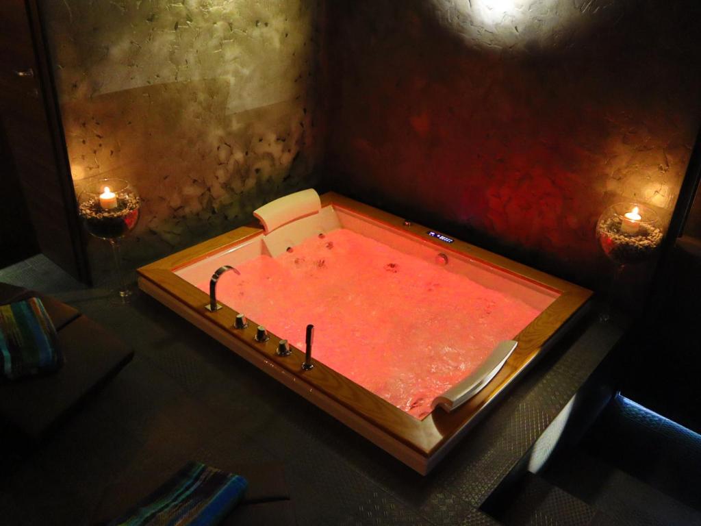 a red bath tub sitting on top of a table at Cactus house relax in Corchiano