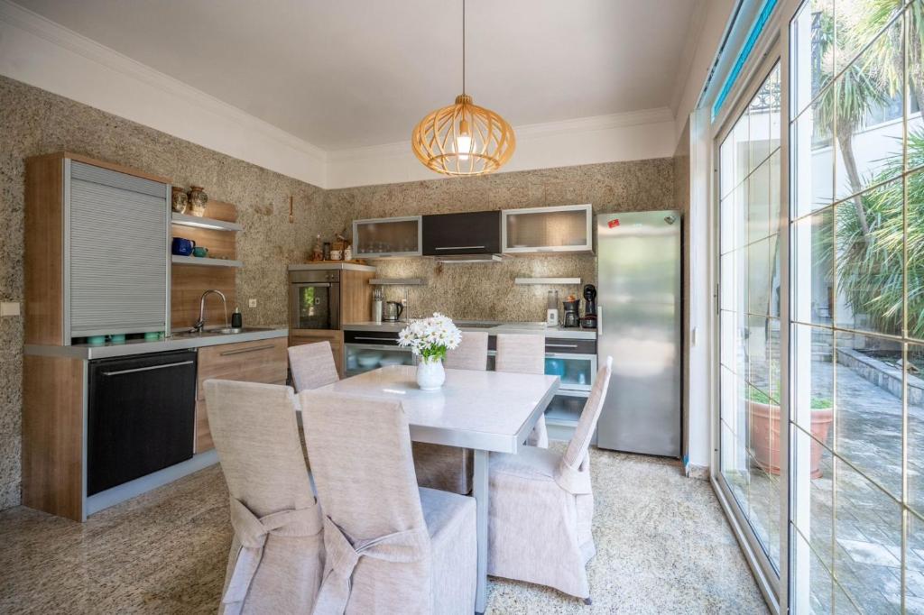 a kitchen with a table and chairs and a refrigerator at Villa Nautica in Herceg-Novi