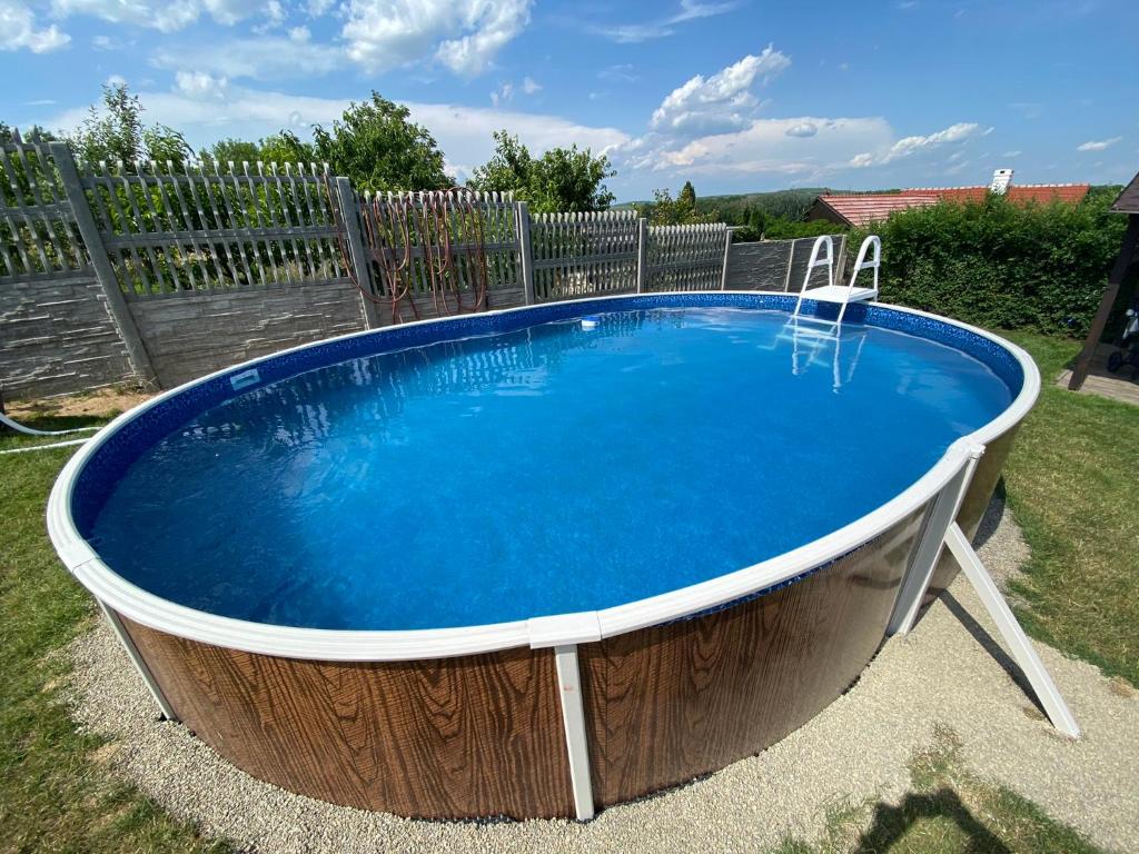 a large circular pool with a table and chairs in a yard at Apartmány u Moravčíků in Bulhary