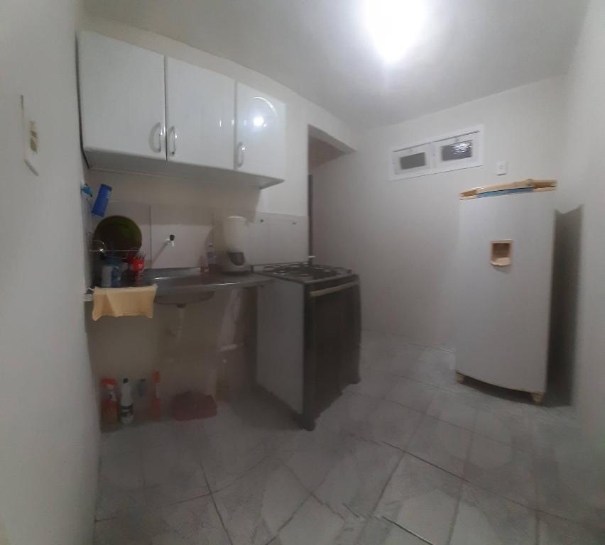 a kitchen with a sink and a refrigerator at Espaço Alternativo in Recife