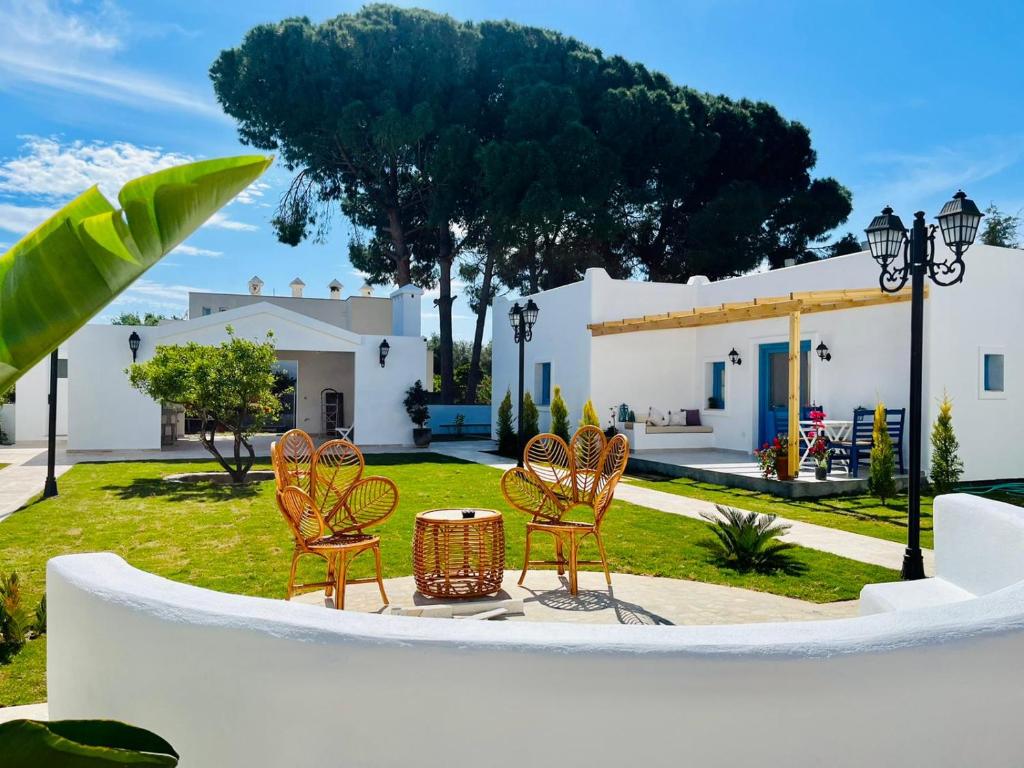 a group of chairs and a table in a yard at Jakaranda Unique Apart in Bodrum City