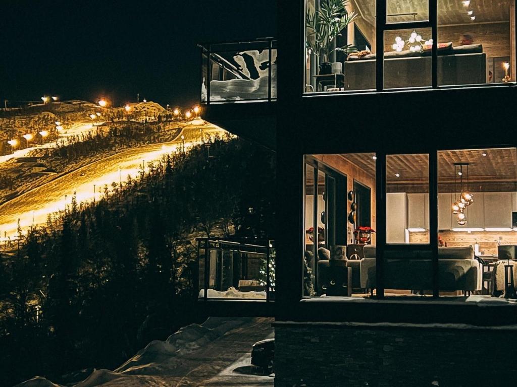 a building with a view of a street at night at Ny luksus leilighet -ski in out i Hemsedal Skarsnuten 905 in Hemsedal