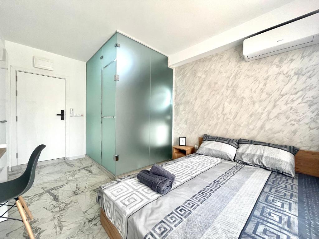 a bedroom with a bed and a glass wall at GlassRoom- Самостоятелна стая Private room in Varna City