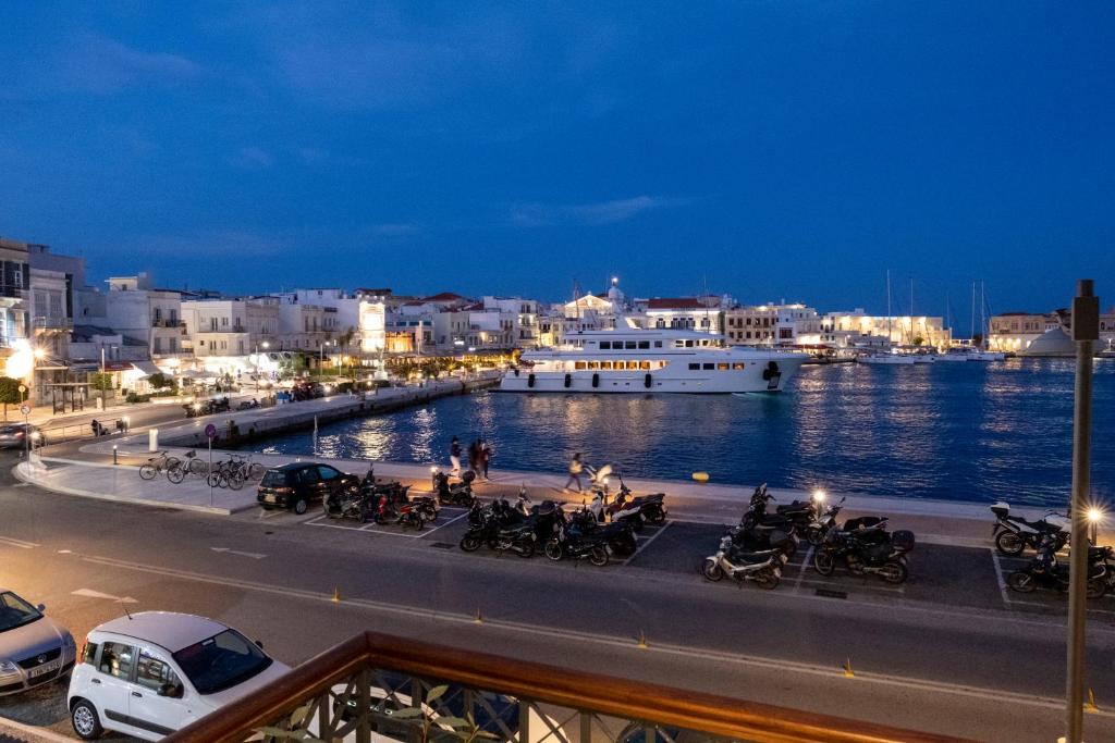 a boat is docked in a harbor at night at VENUS LUXURY APARTMENT in Ermoupoli