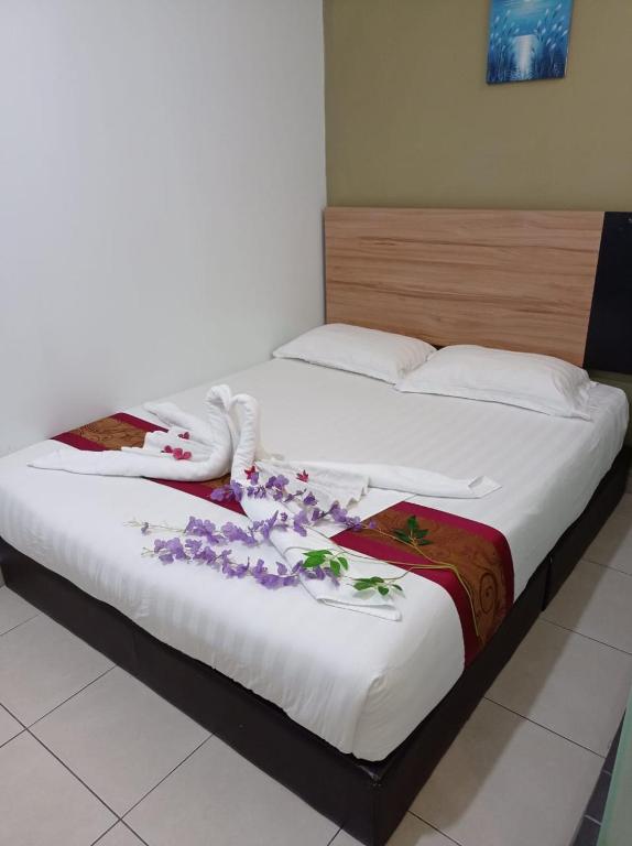 Postel nebo postele na pokoji v ubytování Amigo Hotel