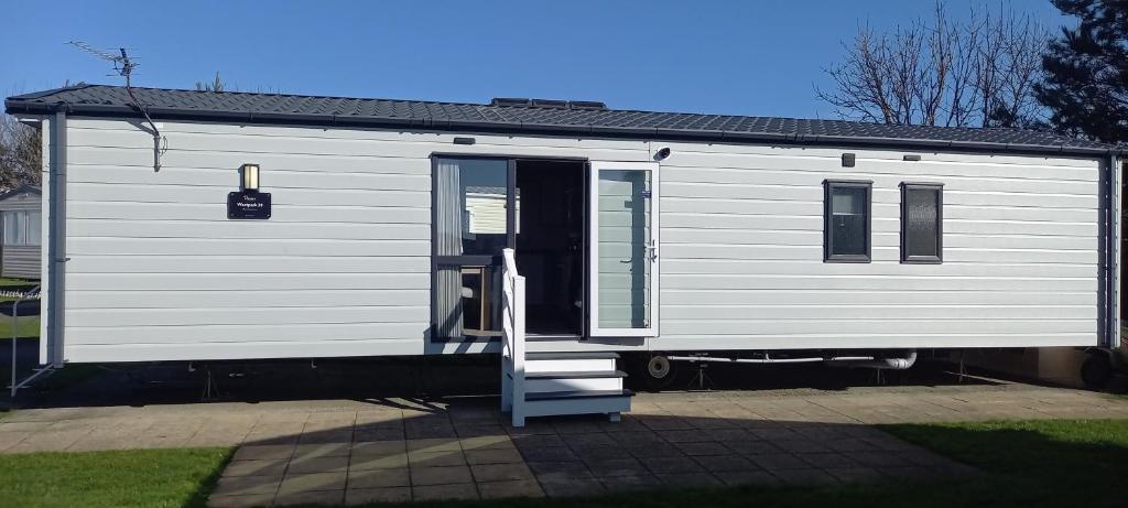 a white trailer with a staircase leading to a door at Withernsea luxury caravan hire in Waxholme