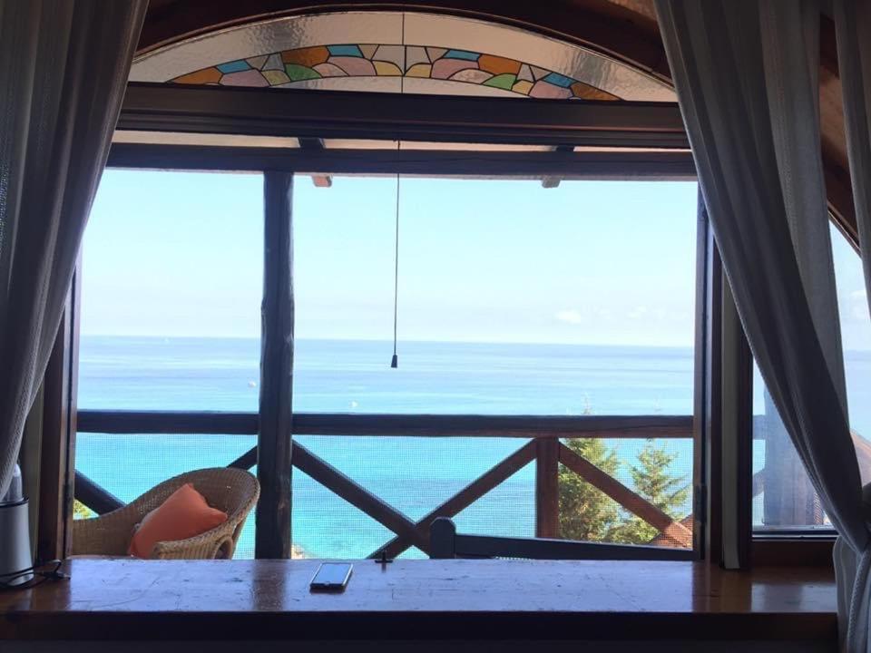 a room with a window with a view of the ocean at Villa Tina Tropea Costa dei Monaci Parghelia, sabbia fine e bianca e mare cristallino in Mandaradoni
