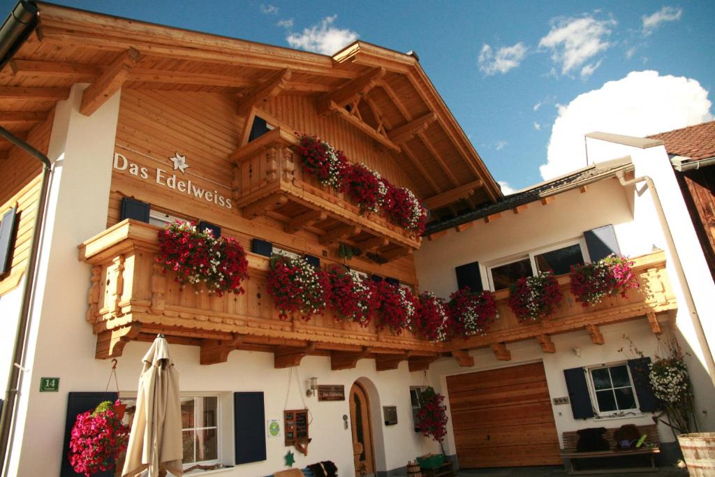 a building with flower boxes on the side of it at Das Edelweiss in Grän