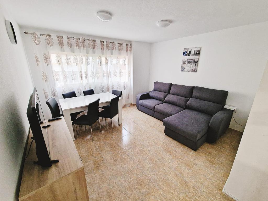 a living room with a couch and a table at RUZAFA 17, OLD TOWN in Benidorm