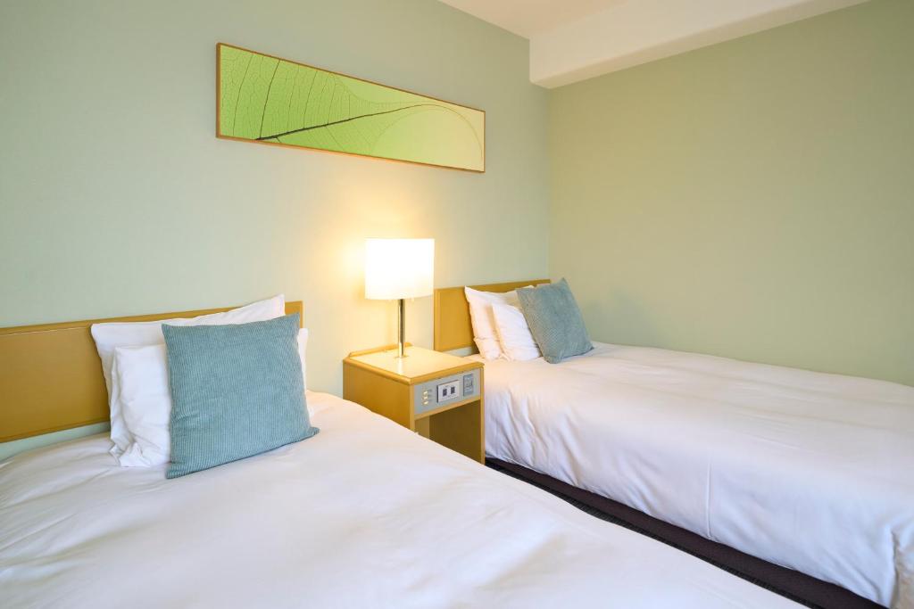 Postel nebo postele na pokoji v ubytování Hotel Resol Machida