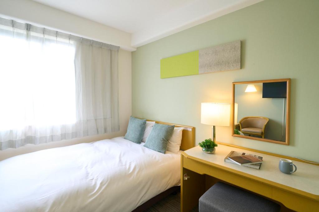 Postel nebo postele na pokoji v ubytování Hotel Resol Machida