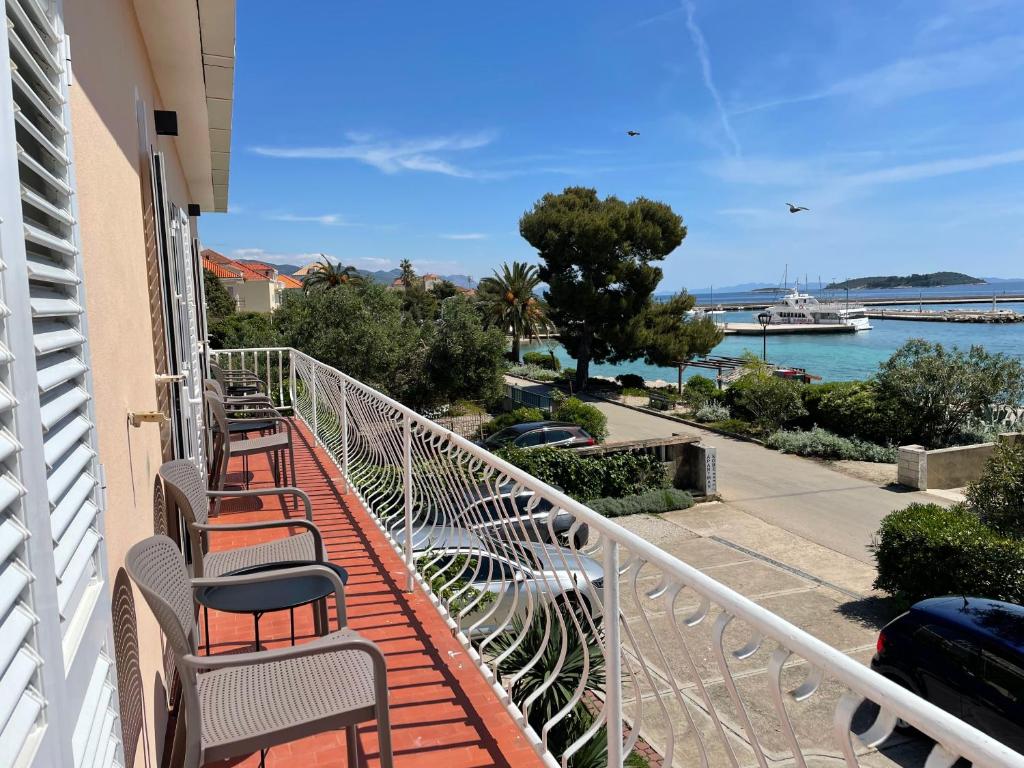 a balcony with chairs and a view of the water at Apartment Seaside Orebić in Orebić