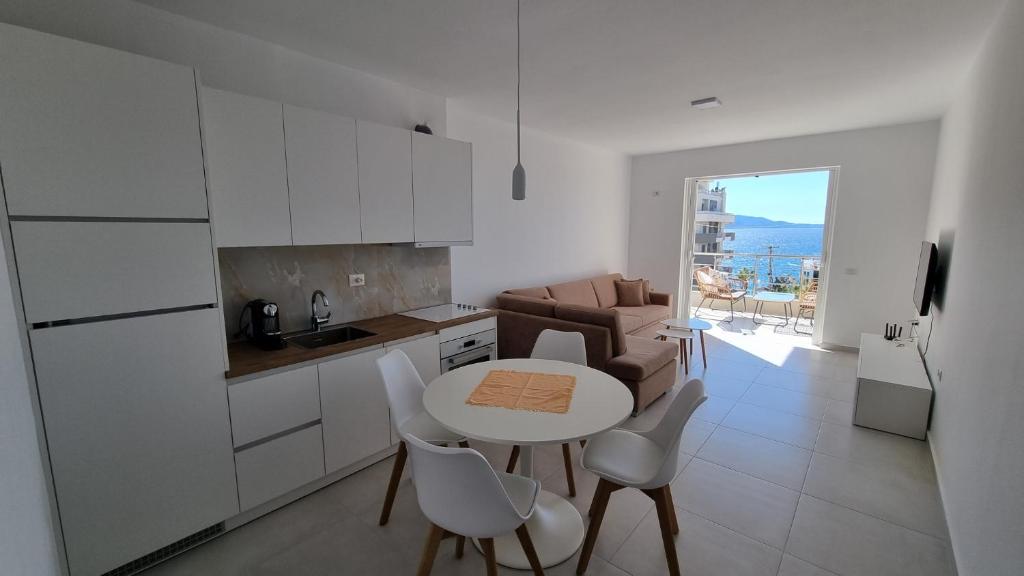 eine Küche mit einem Tisch und Stühlen im Zimmer in der Unterkunft Toni Apartment in Sarandë