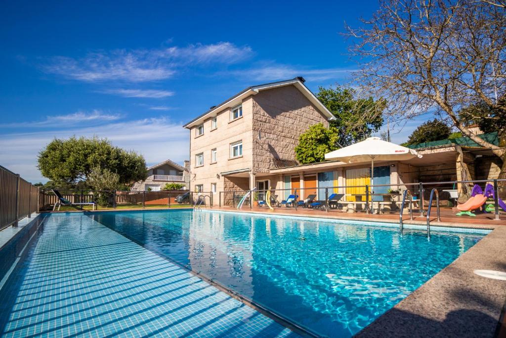 una piscina di fronte a un edificio di MIRADOR DA GOUXA en Pontevedra a Pontevedra