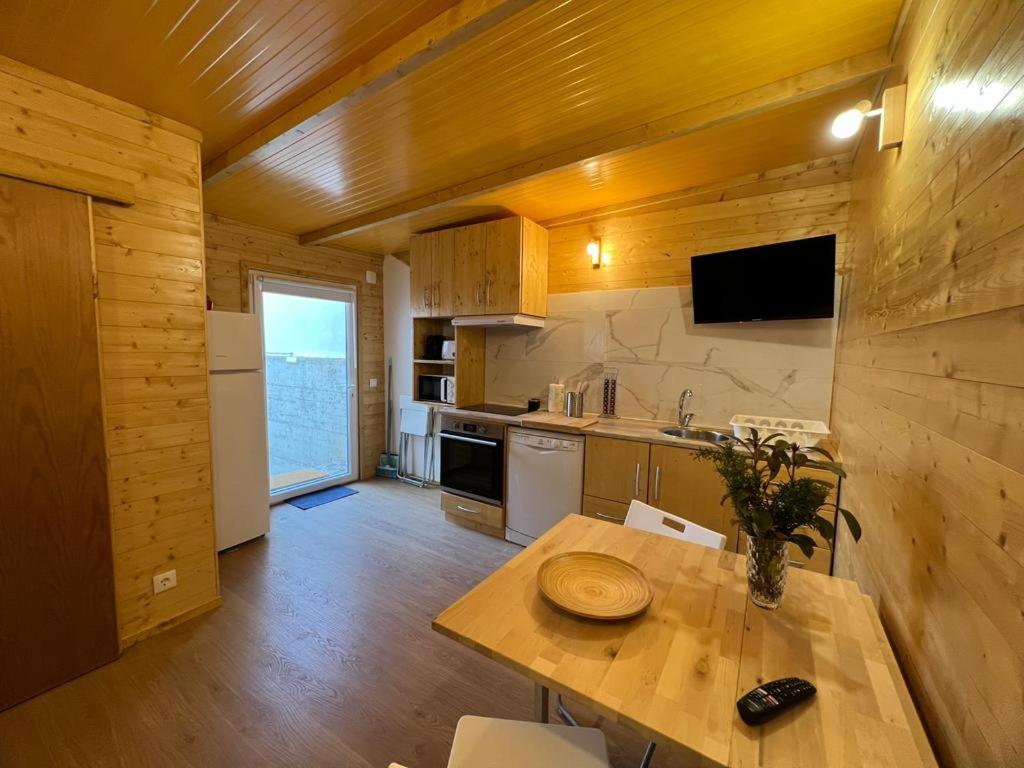 a kitchen with a table and a counter top at Casa da Praia in Carvalhal
