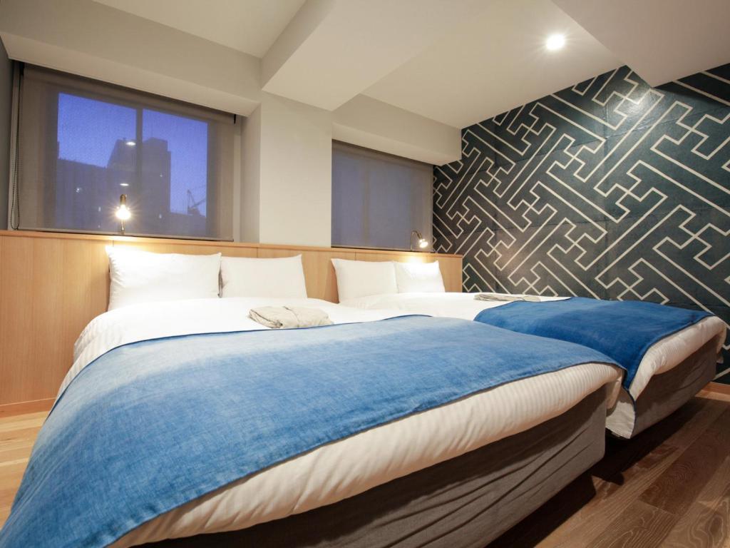 Postel nebo postele na pokoji v ubytování Asakusa Kokono Club Hotel