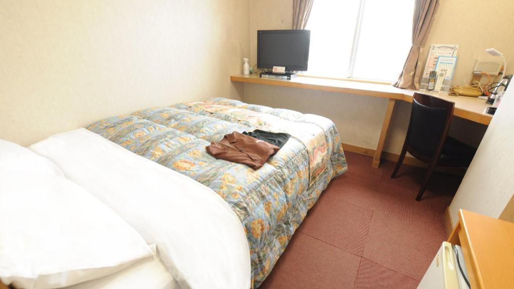 Postel nebo postele na pokoji v ubytování Handa Station Hotel