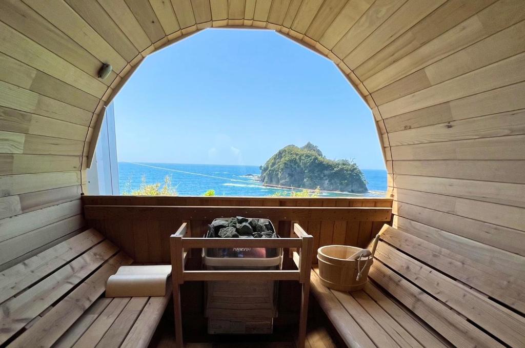 an inside view of a sauna with an arched window at il azzurri in Nishiizu