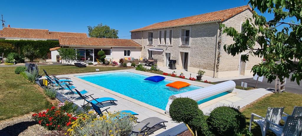 uma piscina com escorrega em frente a uma casa em Gîte La Gloriette 4 à 6 personnes proche Futuroscope em Neuville-du-Poitou